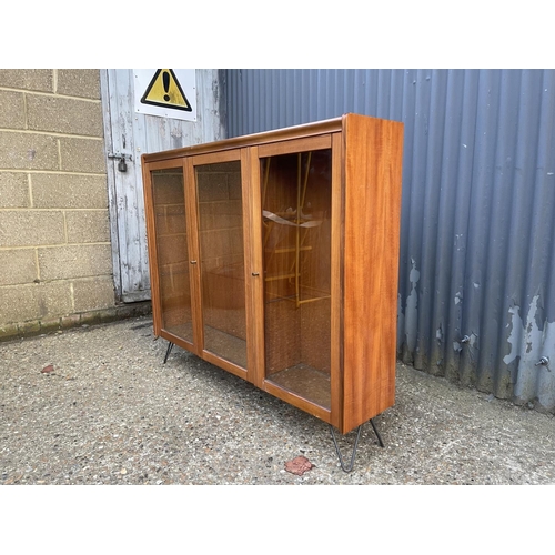 40 - Mid century glazed teak bookcase on hairpin legs height 106, width 127 depth 26 cms