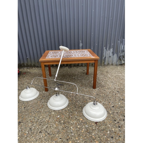 41 - A mid century teak tile top coffee table together with a modern light fitting