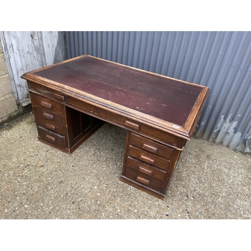 44 - A 20th century oak twin pedestal office desk with storage to the pedestal ends 152x90x75