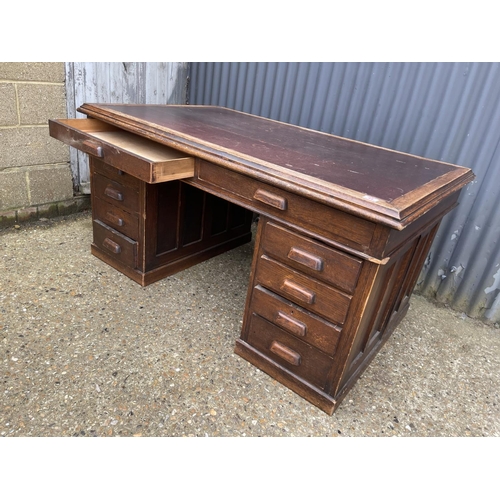 44 - A 20th century oak twin pedestal office desk with storage to the pedestal ends 152x90x75