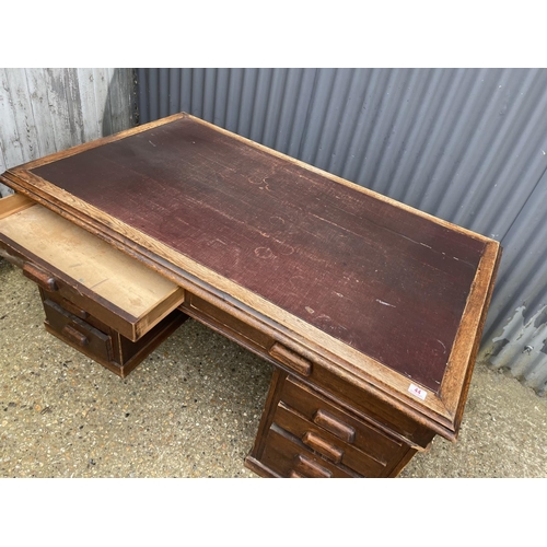 44 - A 20th century oak twin pedestal office desk with storage to the pedestal ends 152x90x75