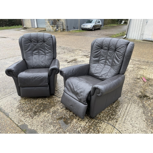 55 - A pair of brown leather electric recliner armchairs