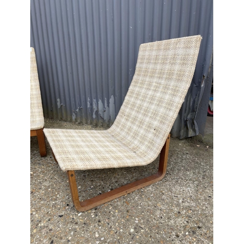 6 - A pair of danish teak framed lounger chairs, each labelled with danish quality control mark 'MADE IN... 