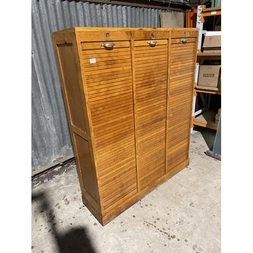 63 - A large three section tambour cabinet with one key 124x35x150