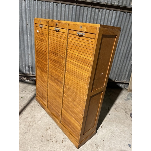 63 - A large three section tambour cabinet with one key 124x35x150