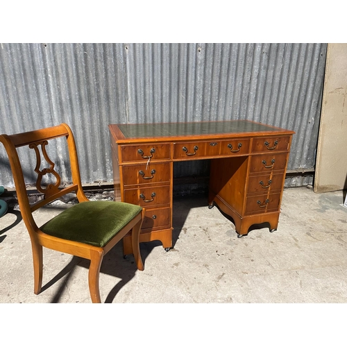 70 - A reproduction yew kneehole desk together with chair