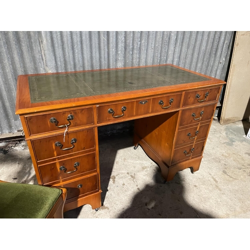 70 - A reproduction yew kneehole desk together with chair