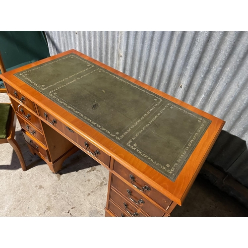 70 - A reproduction yew kneehole desk together with chair