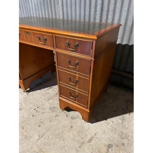 70 - A reproduction yew kneehole desk together with chair