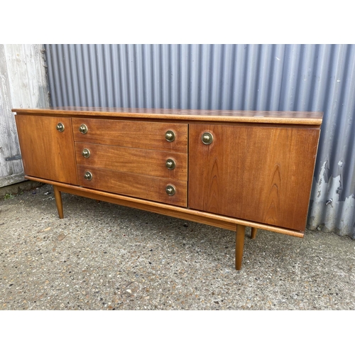 8 - A mid century teak sideboard with three drawers and two cupboard doors  184 x 46x77