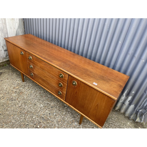 8 - A mid century teak sideboard with three drawers and two cupboard doors  184 x 46x77