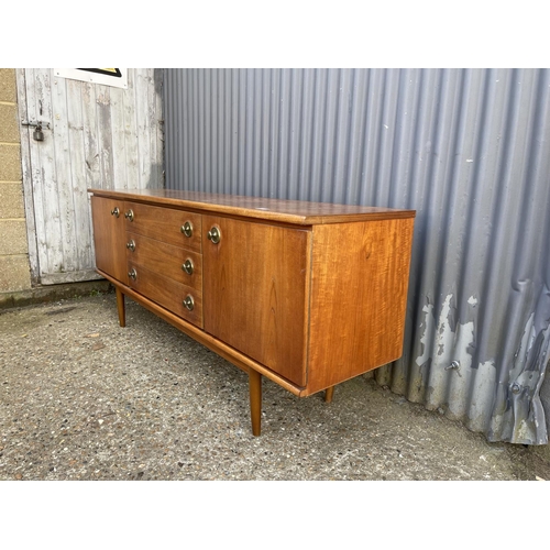 8 - A mid century teak sideboard with three drawers and two cupboard doors  184 x 46x77