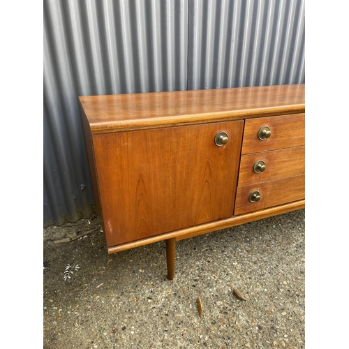 8 - A mid century teak sideboard with three drawers and two cupboard doors  184 x 46x77