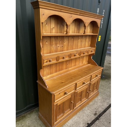 290A - A solid pine farmhouse dresser with plate rack back over three drawer base 152x50x180