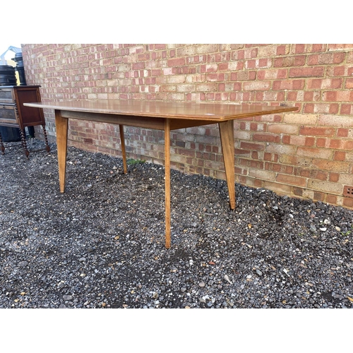 10 - A mid century teak plank top dining table possibly by Alfred Cox 199x94x74