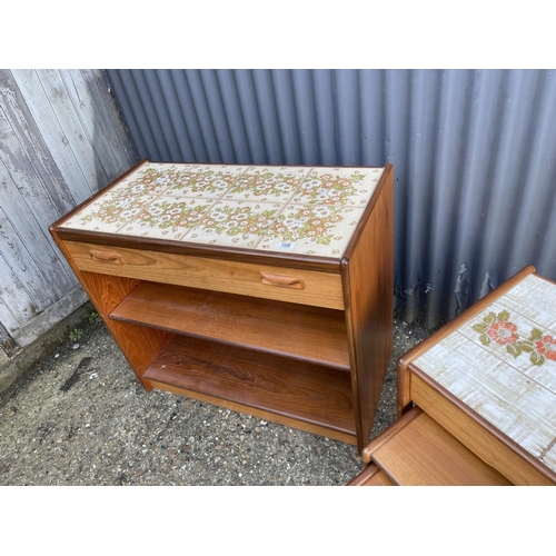 108 - A mid century teak tile top sideboard / bookcase together with a teak tile top nest of three with dr... 