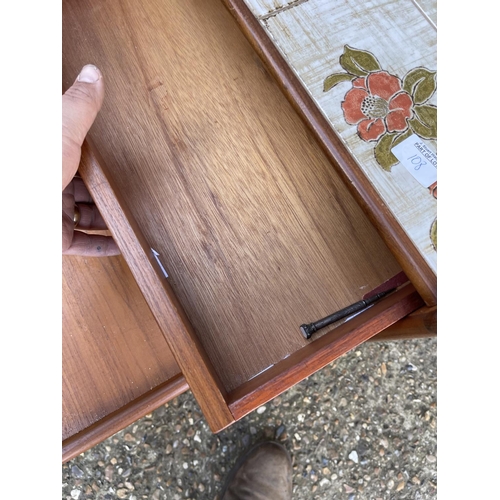 108 - A mid century teak tile top sideboard / bookcase together with a teak tile top nest of three with dr... 