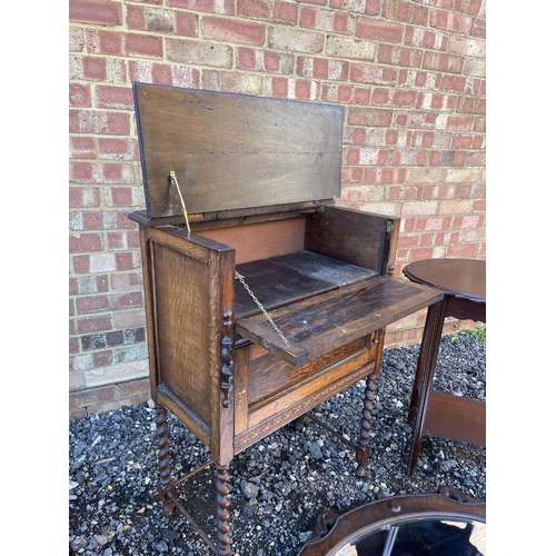 11 - An oak drinks / gramophone cabinet together with an oak mirror and a occasional table