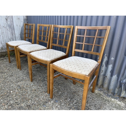 113 - A set of four early 20th century oak lattice back dining chairs