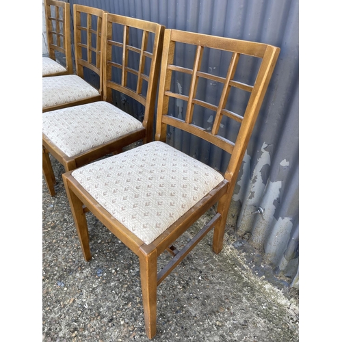 113 - A set of four early 20th century oak lattice back dining chairs