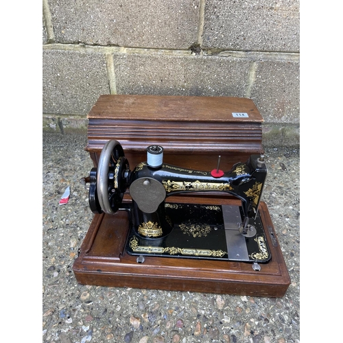 114 - A cased singer sewing machine