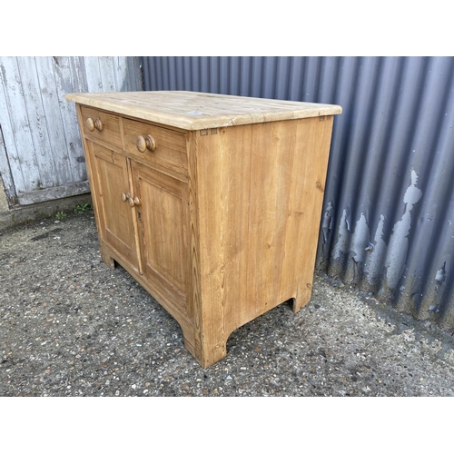 136 - A small country pine sideboard with two drawers over two doors 92x56x78