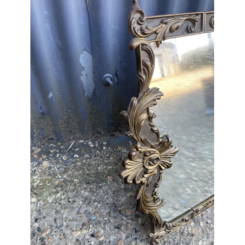 138 - An ornate Italian brass framed wall mirror 80x40