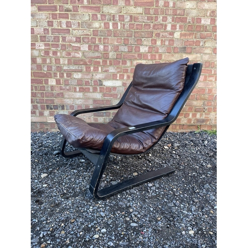 14 - A Danish style cantilever lounger chair with brown leather seat