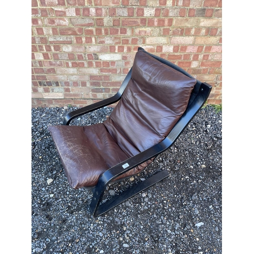 14 - A Danish style cantilever lounger chair with brown leather seat