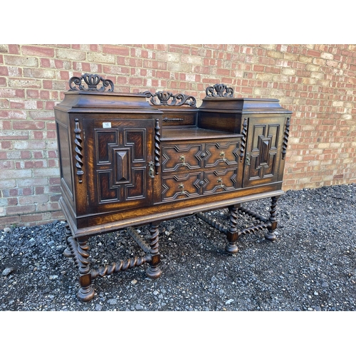 15 - An oak Jacobean revival sideboard with ornate carved decoration.  154x 56 x120