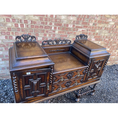 15 - An oak Jacobean revival sideboard with ornate carved decoration.  154x 56 x120