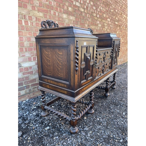 15 - An oak Jacobean revival sideboard with ornate carved decoration.  154x 56 x120