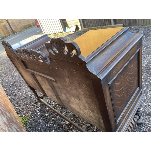 15 - An oak Jacobean revival sideboard with ornate carved decoration.  154x 56 x120