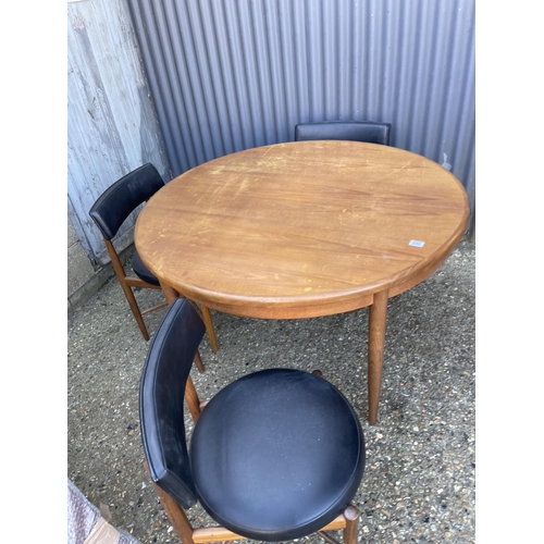 150 - A g plan fresco teak circular extending dining table together with four matching g plan dining chair... 