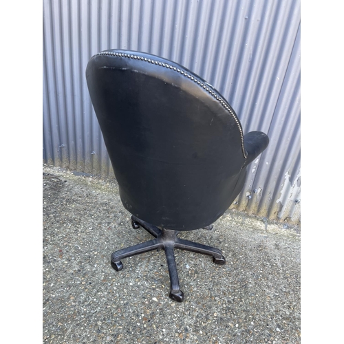 181 - A black leather swivel desk chair