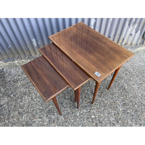 182 - A mid century teak style nest of three