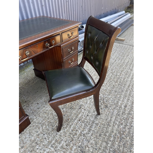 192 - A reproduction mahogany twin pedestal desk with a green leather top  together with a green buttoned ... 