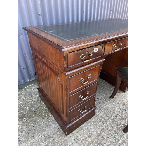 192 - A reproduction mahogany twin pedestal desk with a green leather top  together with a green buttoned ... 