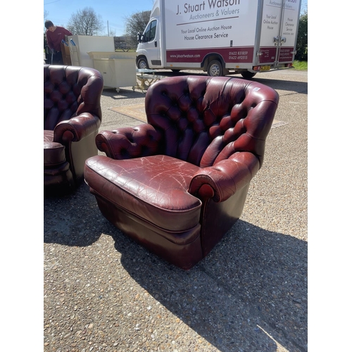 199 - A pair of oxblood red leather chesterfield armchairs