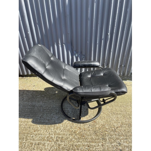 206 - A modern black leather recliner chair