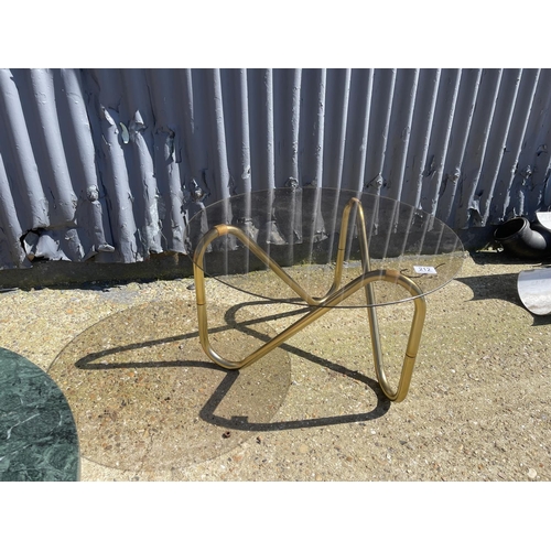 212 - A retro onyx topped circular coffee table together with a retro glass topped coffee table