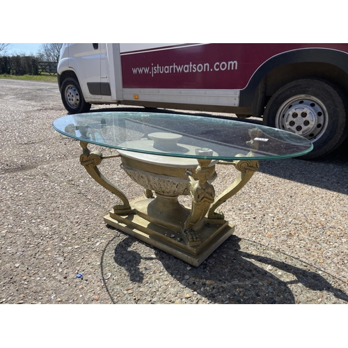 213 - A brass effect figure coffee table with glass top