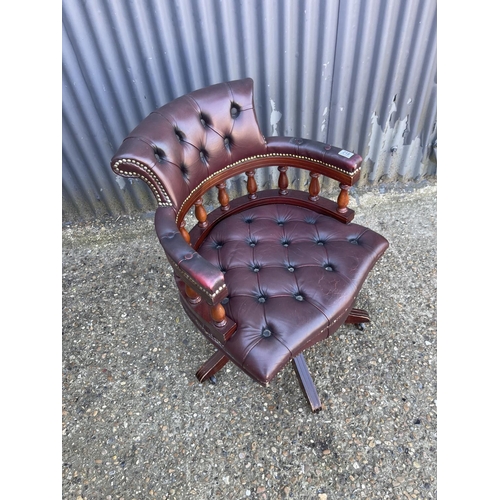 218 - A burgundy leather chesterfield captains style swivel desk chair