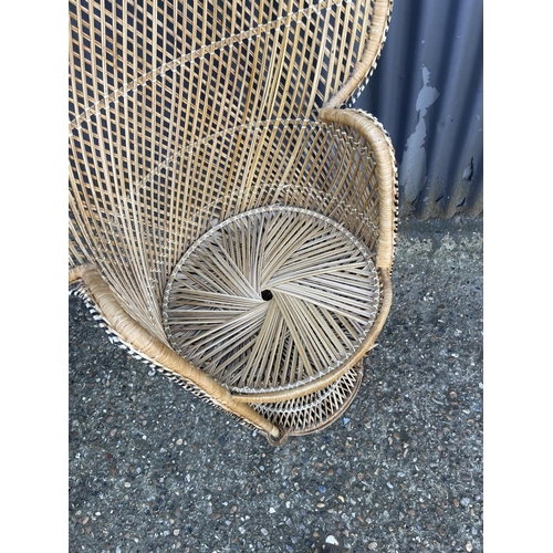 219 - A mid century PEACOCK back rattan chair