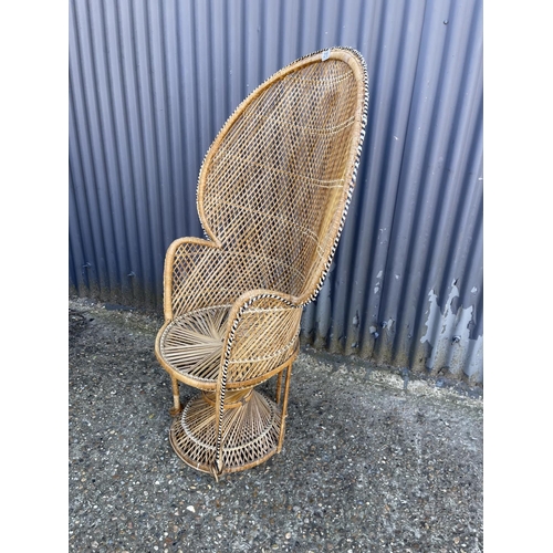 219 - A mid century PEACOCK back rattan chair