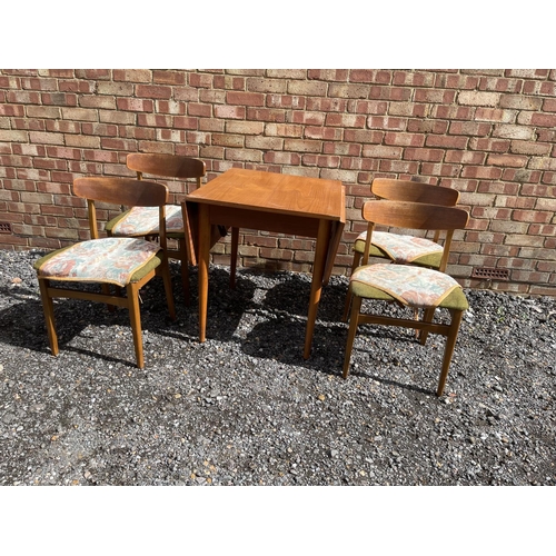 22 - A teak drop leaf table together with four chairs