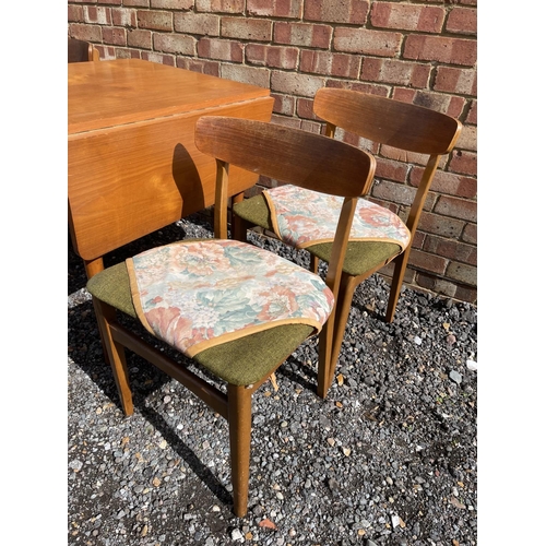 22 - A teak drop leaf table together with four chairs