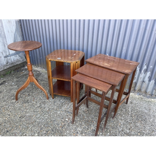 236 - A mahogany snap top tripod table together with a book table and a nest of three