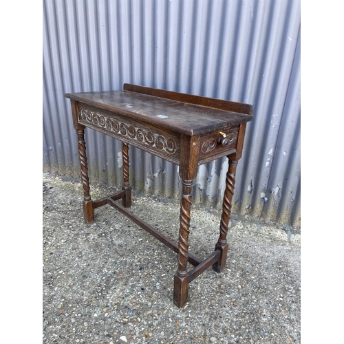 251 - A carved oak hall table with drawer to the end 84x35x77