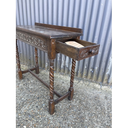 251 - A carved oak hall table with drawer to the end 84x35x77